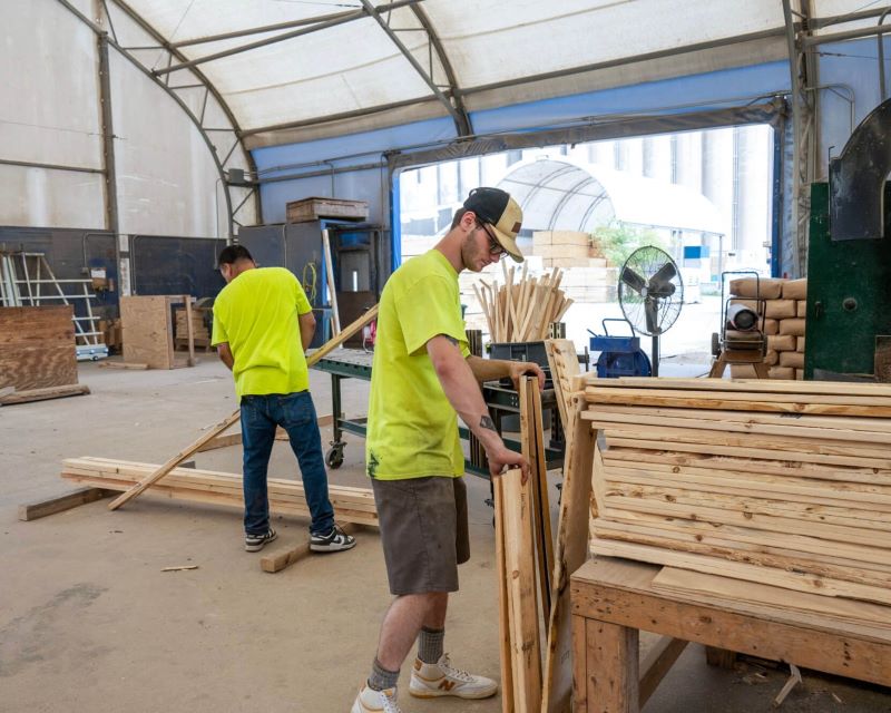 a group of men in a lumber supply shop